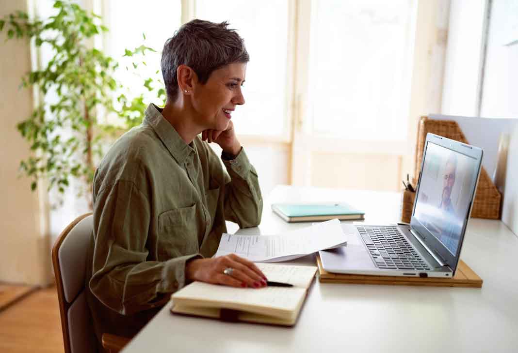 Woman at a laption on the phone